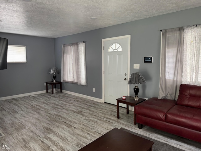 322 S Rural St, Indianapolis, IN 46201 - living room with plenty of natural light, wood finished floors, a textured ceiling, and baseboards