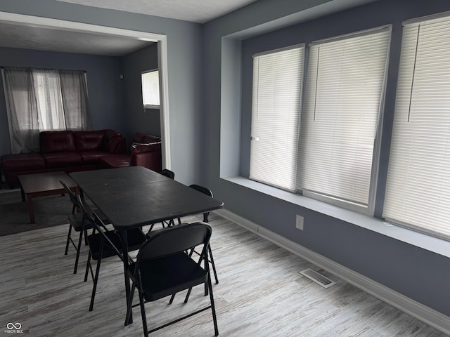 322 S Rural St, Indianapolis, IN 46201 - dining space featuring baseboards and wood finished floors