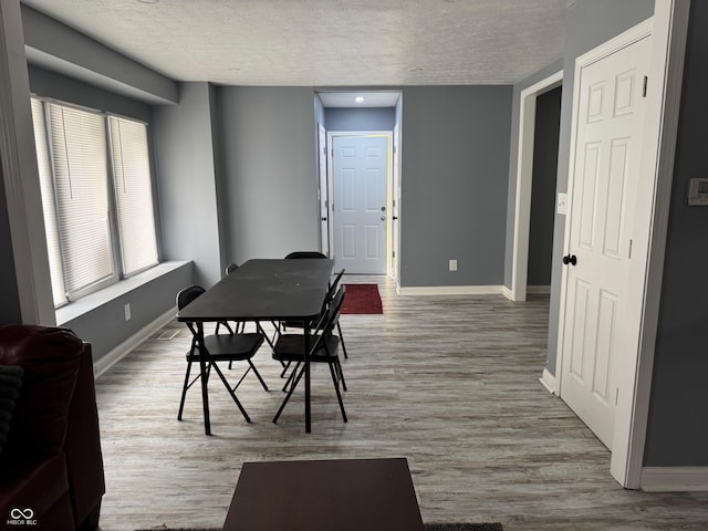 322 S Rural St, Indianapolis, IN 46201 - dining area featuring a textured ceiling, baseboards, and wood finished floors