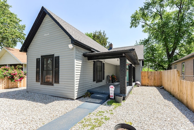 853 S Belleview Pl, Indianapolis, IN 46221 - view of front of property featuring a shingled roof and a chimney
