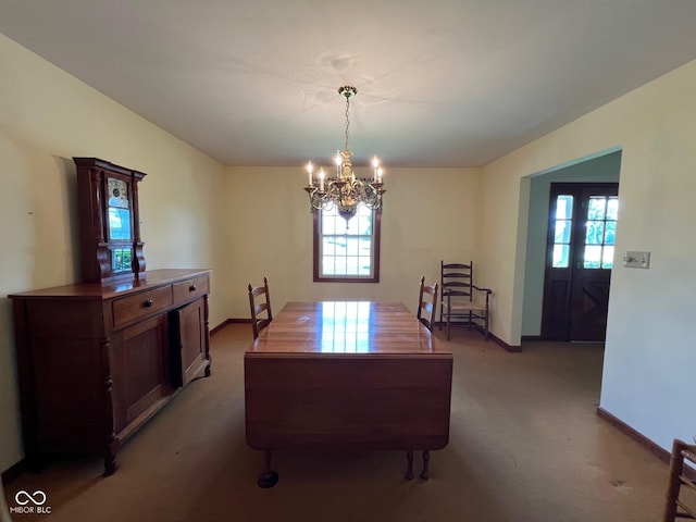 3654 W Mecca Rd, Rockville, IN 47872 - carpeted dining area featuring a chandelier, plenty of natural light, and baseboards