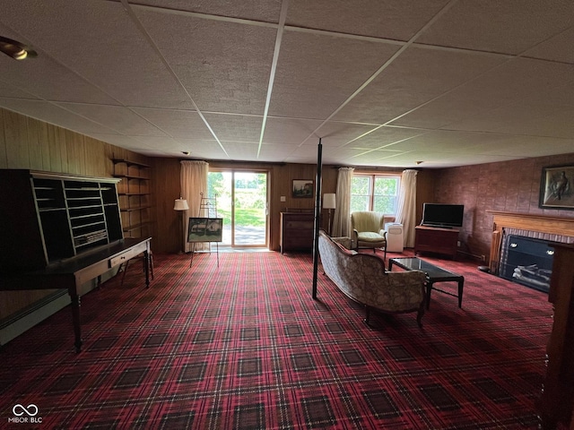 3654 W Mecca Rd, Rockville, IN 47872 - living area featuring a fireplace, plenty of natural light, carpet flooring, a paneled ceiling, and wood walls