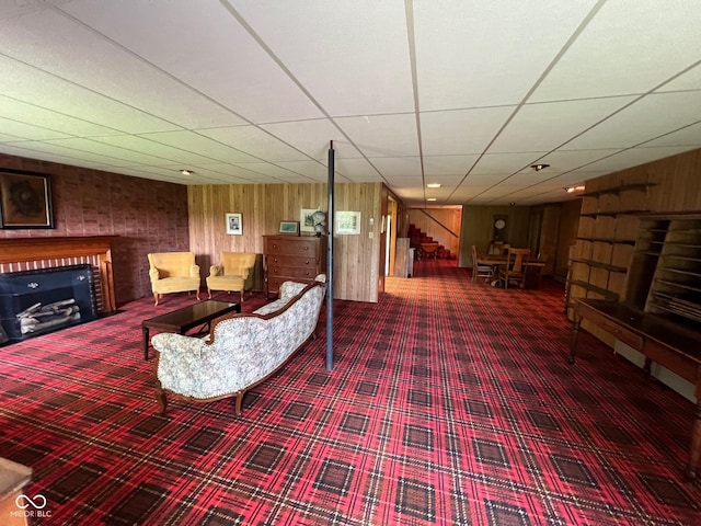 3654 W Mecca Rd, Rockville, IN 47872 - living area featuring carpet flooring, a drop ceiling, a fireplace, and wood walls