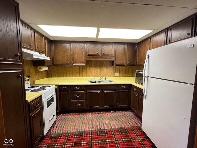 3654 W Mecca Rd, Rockville, IN 47872 - kitchen with white appliances, a sink, under cabinet range hood, light countertops, and dark colored carpet