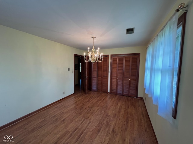 3654 W Mecca Rd, Rockville, IN 47872 - unfurnished dining area featuring a chandelier, wood finished floors, and baseboards