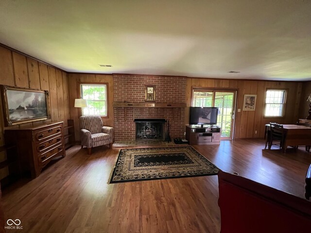 3654 W Mecca Rd, Rockville, IN 47872 - living room featuring wood finished floors, a brick fireplace, and wood walls