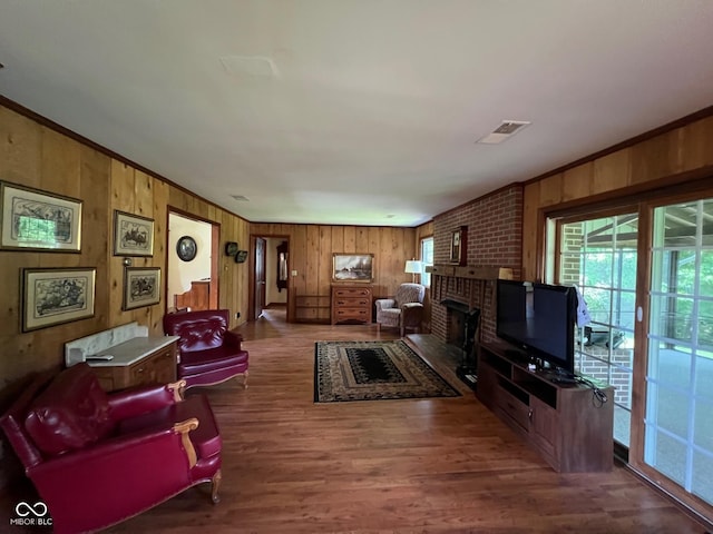 3654 W Mecca Rd, Rockville, IN 47872 - living room featuring wooden walls, a fireplace, wood finished floors, and crown molding