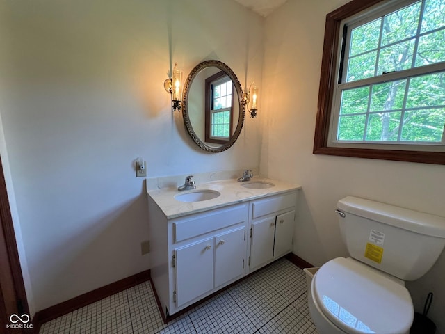 3654 W Mecca Rd, Rockville, IN 47872 - bathroom featuring healthy amount of natural light, toilet, double vanity, and baseboards
