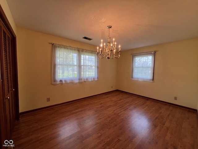 3654 W Mecca Rd, Rockville, IN 47872 - unfurnished dining area with a chandelier, wood finished floors, and baseboards