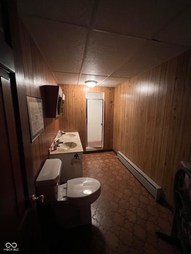 3654 W Mecca Rd, Rockville, IN 47872 - bathroom featuring a baseboard heating unit, toilet, wooden walls, a paneled ceiling, and a sink