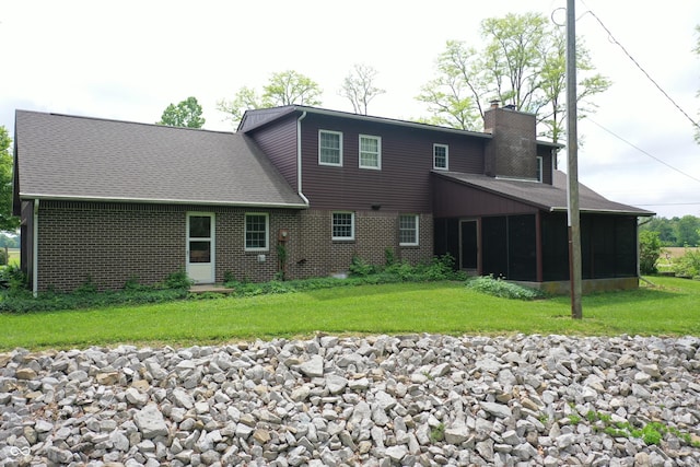 3654 W Mecca Rd, Rockville, IN 47872 - back of property with a chimney, a sunroom, brick siding, and a lawn