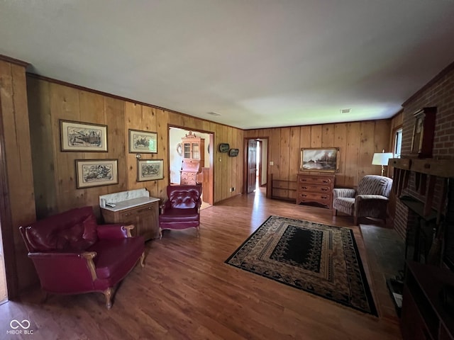 3654 W Mecca Rd, Rockville, IN 47872 - living room featuring wood finished floors, wooden walls, and a brick fireplace