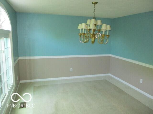 4667 Sundance Trl, Indianapolis, IN 46239 - unfurnished dining area featuring a chandelier, carpet, and baseboards