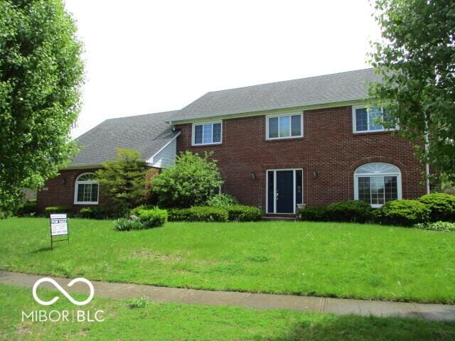 4667 Sundance Trl, Indianapolis, IN 46239 - colonial home featuring a front yard and brick siding