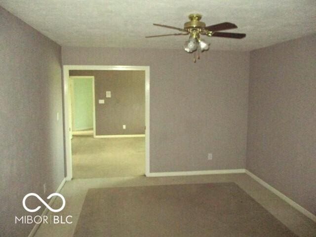 4667 Sundance Trl, Indianapolis, IN 46239 - spare room with baseboards, ceiling fan, and carpet