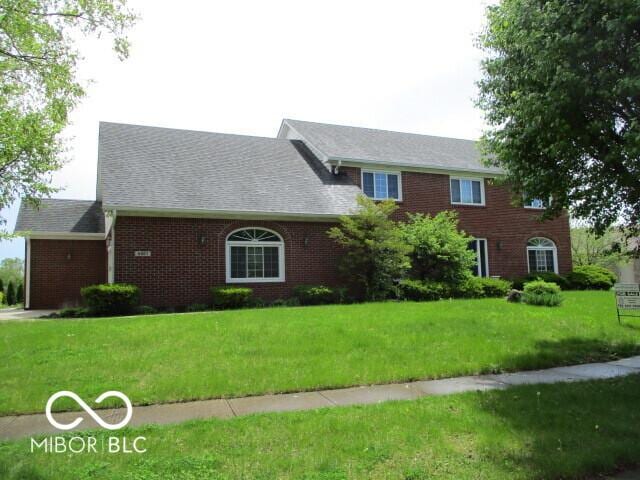 4667 Sundance Trl, Indianapolis, IN 46239 - view of front facade featuring brick siding, a front lawn, and a shingled roof