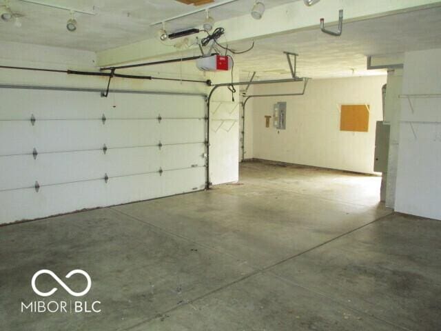 4667 Sundance Trl, Indianapolis, IN 46239 - garage featuring a garage door opener and electric panel