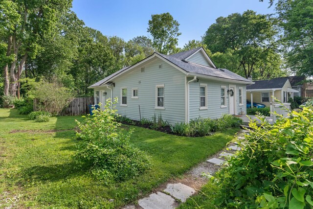 1802 E 66th St, Indianapolis, IN 46220 - view of side of property featuring a shingled roof