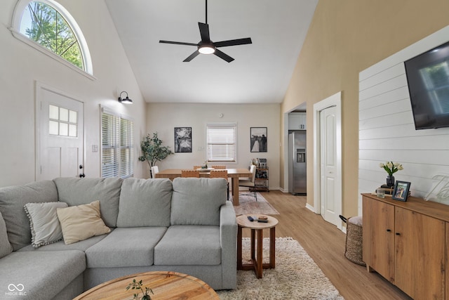 1802 E 66th St, Indianapolis, IN 46220 - living area featuring high vaulted ceiling, a ceiling fan, light wood-type flooring, and baseboards