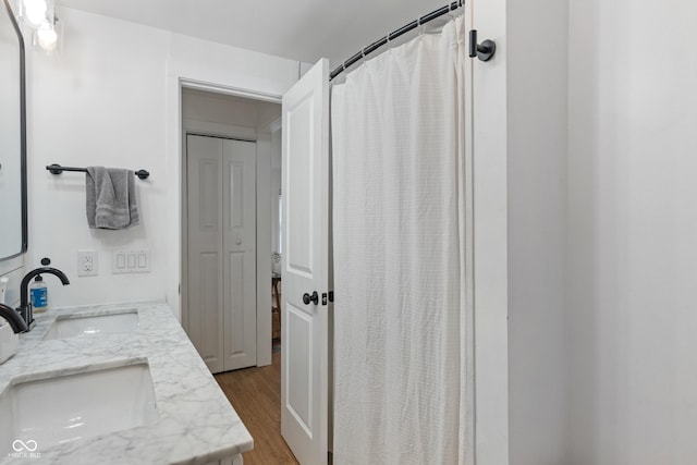 1802 E 66th St, Indianapolis, IN 46220 - full bathroom with wood finished floors, a sink, and a shower with curtain