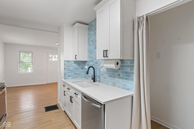 1802 E 66th St, Indianapolis, IN 46220 - kitchen with appliances with stainless steel finishes, backsplash, white cabinetry, light wood-style floors, and light stone countertops