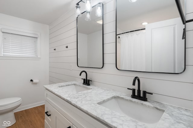 1802 E 66th St, Indianapolis, IN 46220 - full bath featuring double vanity, wood finished floors, wood walls, and a shower with shower curtain