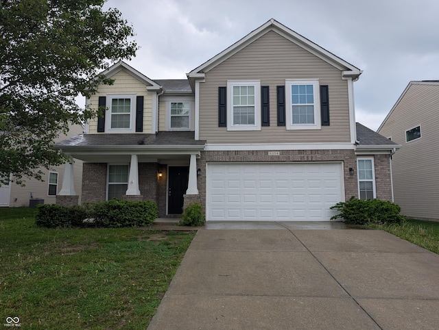 8354 Fieldfare Way, Indianapolis, IN 46237 - view of front of property with concrete driveway, a garage, a front yard, and brick siding
