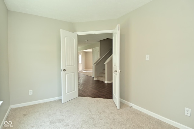 8354 Fieldfare Way, Indianapolis, IN 46237 - carpeted empty room featuring baseboards and stairs