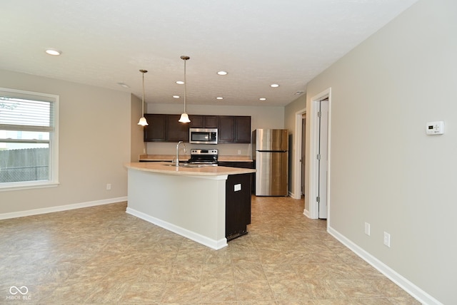 8354 Fieldfare Way, Indianapolis, IN 46237 - kitchen with appliances with stainless steel finishes, light countertops, recessed lighting, dark brown cabinets, and decorative light fixtures