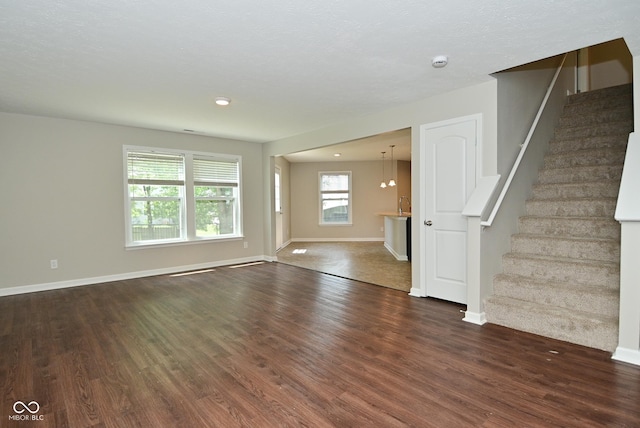 8354 Fieldfare Way, Indianapolis, IN 46237 - unfurnished living room featuring wood finished floors, stairway, baseboards, and recessed lighting