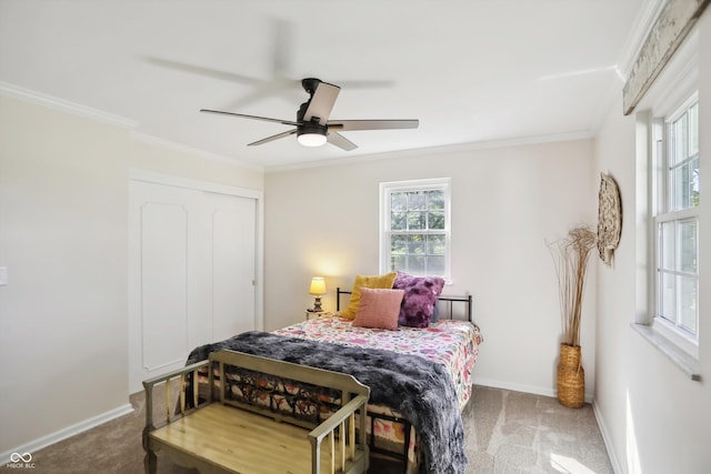 bedroom featuring carpet, crown molding, baseboards, and a closet