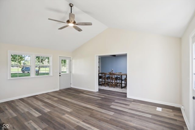 unfurnished living room with ceiling fan, dark wood finished floors, baseboards, and high vaulted ceiling