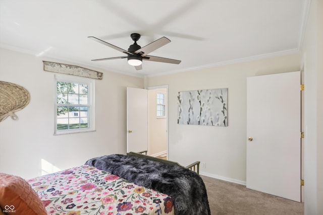 bedroom featuring carpet floors, ornamental molding, ceiling fan, and baseboards