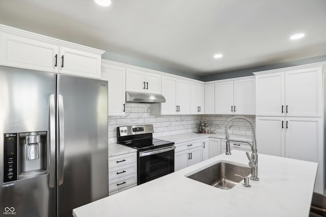 kitchen featuring stainless steel appliances, a sink, under cabinet range hood, white cabinets, and recessed lighting