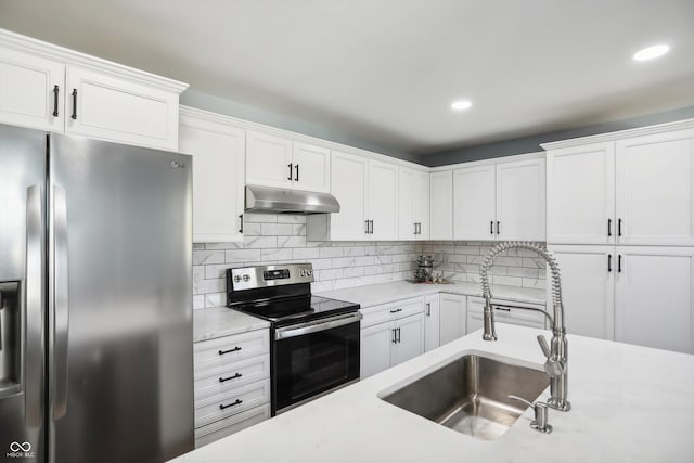 kitchen with appliances with stainless steel finishes, a sink, under cabinet range hood, white cabinetry, and recessed lighting