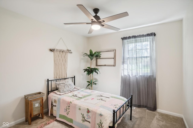 carpeted bedroom featuring baseboards and ceiling fan