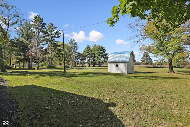 view of green lawn with an outbuilding and a storage unit