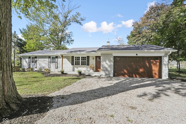 view of front facade featuring an attached garage, driveway, brick siding, and a front lawn
