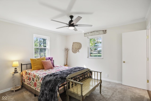 carpeted bedroom with crown molding, multiple windows, baseboards, and a ceiling fan