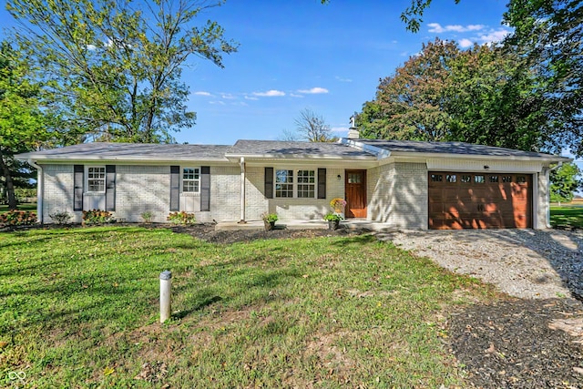 ranch-style house featuring a garage, a front yard, driveway, and brick siding