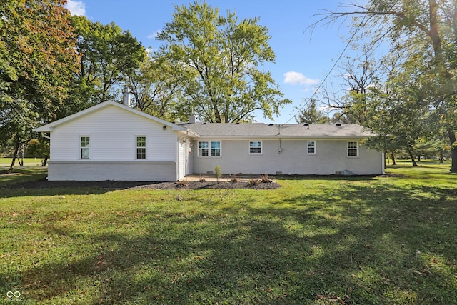 back of house with a yard