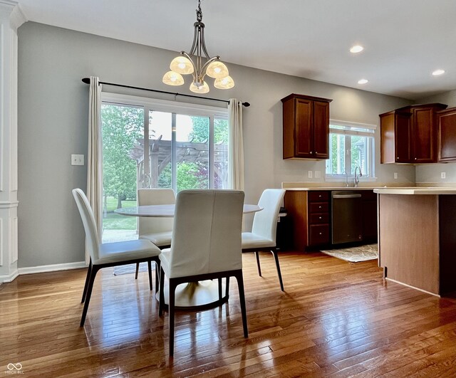dining room with a chandelier, hardwood / wood-style flooring, recessed lighting, and baseboards