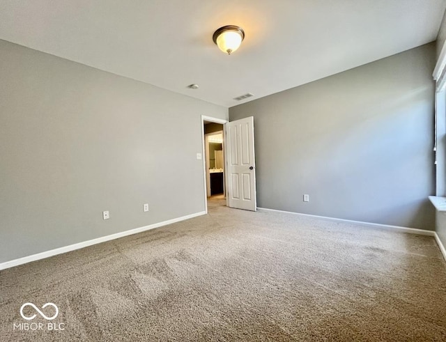 carpeted spare room with baseboards