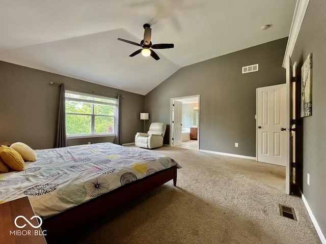 bedroom featuring vaulted ceiling, carpet floors, baseboards, ensuite bath, and a ceiling fan