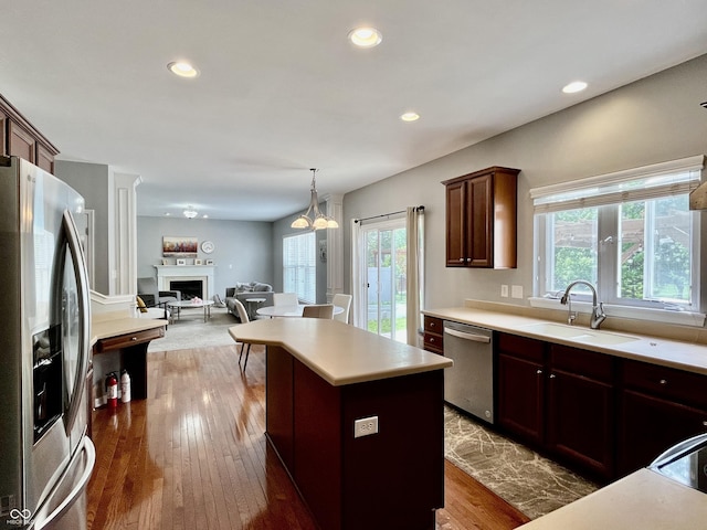 kitchen featuring appliances with stainless steel finishes, a sink, healthy amount of natural light, light countertops, and recessed lighting