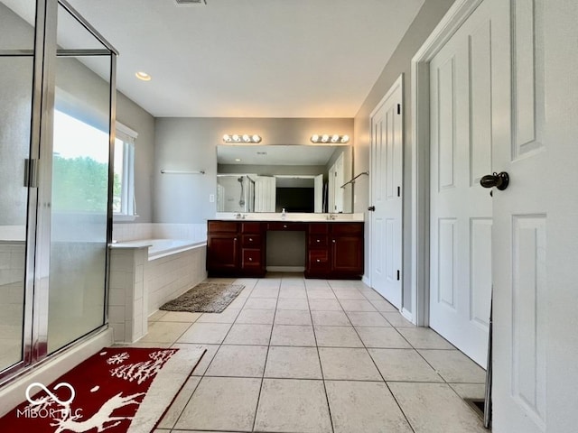 bathroom with a stall shower, a bath, double vanity, tile patterned flooring, and recessed lighting