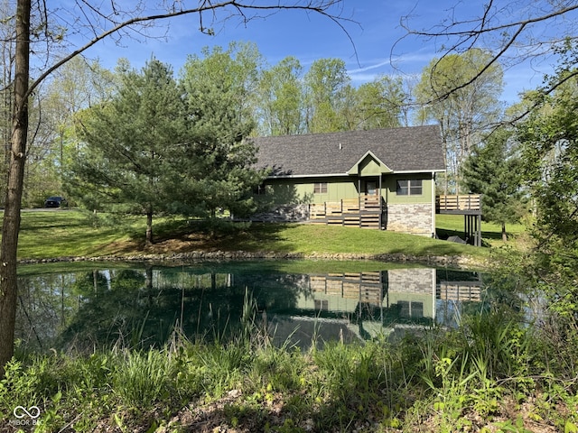 1340 Apache Trl, Martinsville, IN 46151 - rear view of property featuring roof with shingles, a lawn, a water view, and stone siding