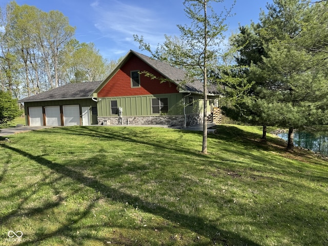 1340 Apache Trl, Martinsville, IN 46151 - back of property with board and batten siding, stone siding, a lawn, an attached garage, and driveway