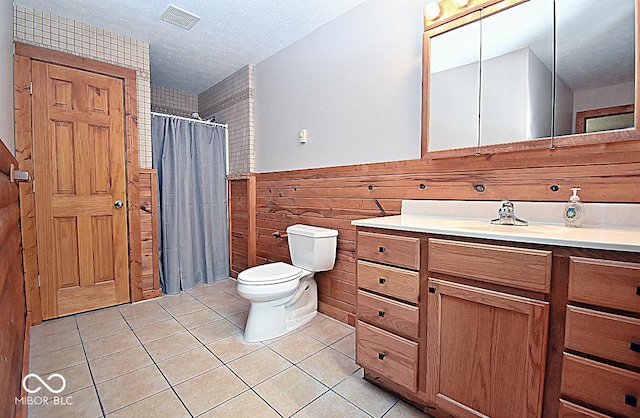 1340 Apache Trl, Martinsville, IN 46151 - bathroom featuring toilet, tile patterned flooring, a textured ceiling, wainscoting, and vanity