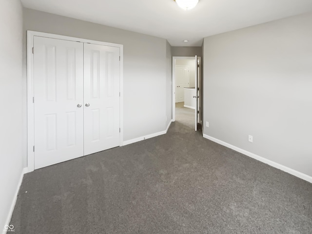 18230 Sandy Cove Ln, Westfield, IN 46074 - unfurnished bedroom with baseboards, dark carpet, and a closet